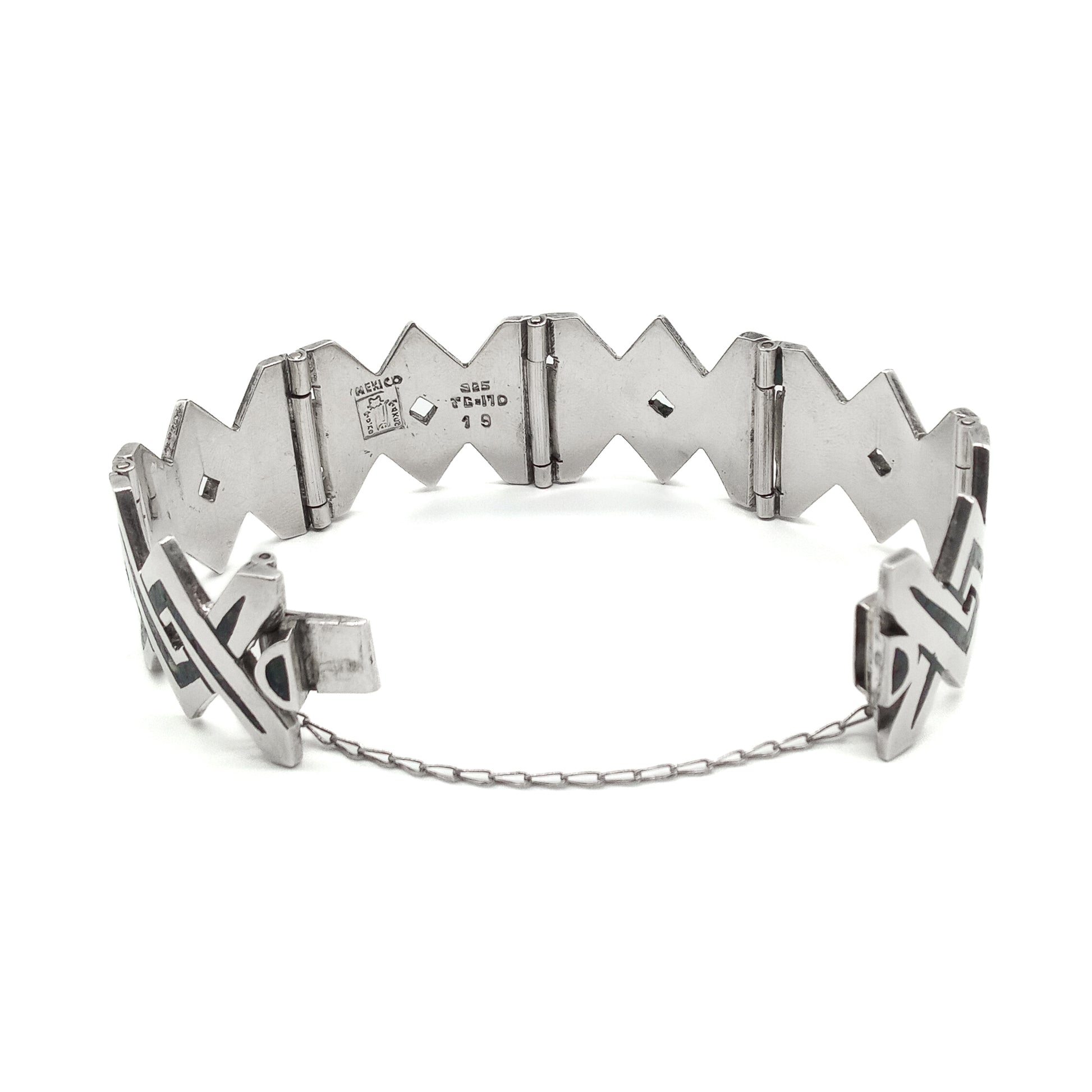 Striking sterling silver mid-century Mexican bracelet with crushed stone inlay work.