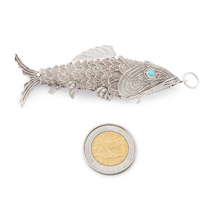 Charming vintage silver filigree spice holder fish pendant with turquoise eyes. The body is articulated with dangling fins.
