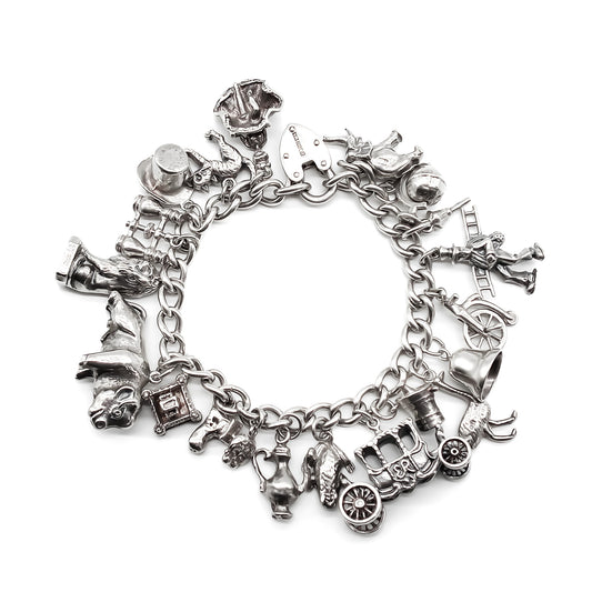Very heavy vintage sterling silver bracelet with a sturdy padlock and twenty unique charms (some with moving parts).