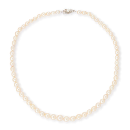 Classic vintage string of graduated seawater pearls with a sterling silver and pearl clasp. The pearls have a creamy hue and a good lustre.