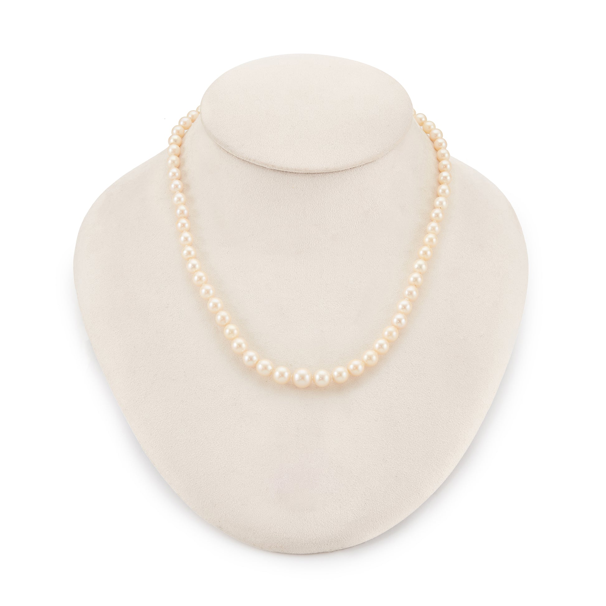 Classic vintage string of graduated seawater pearls with a sterling silver and pearl clasp. The pearls have a creamy hue and a good lustre.