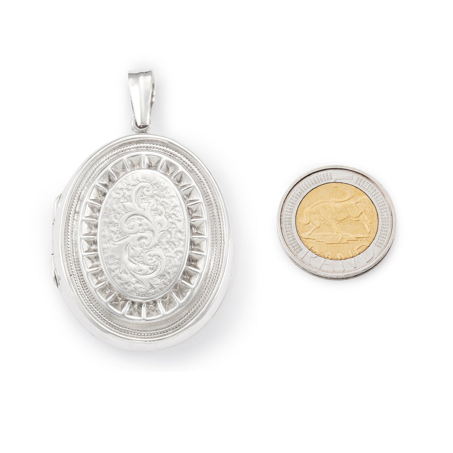 Lovely vintage sterling silver locket with ornate engraving detail on the front.