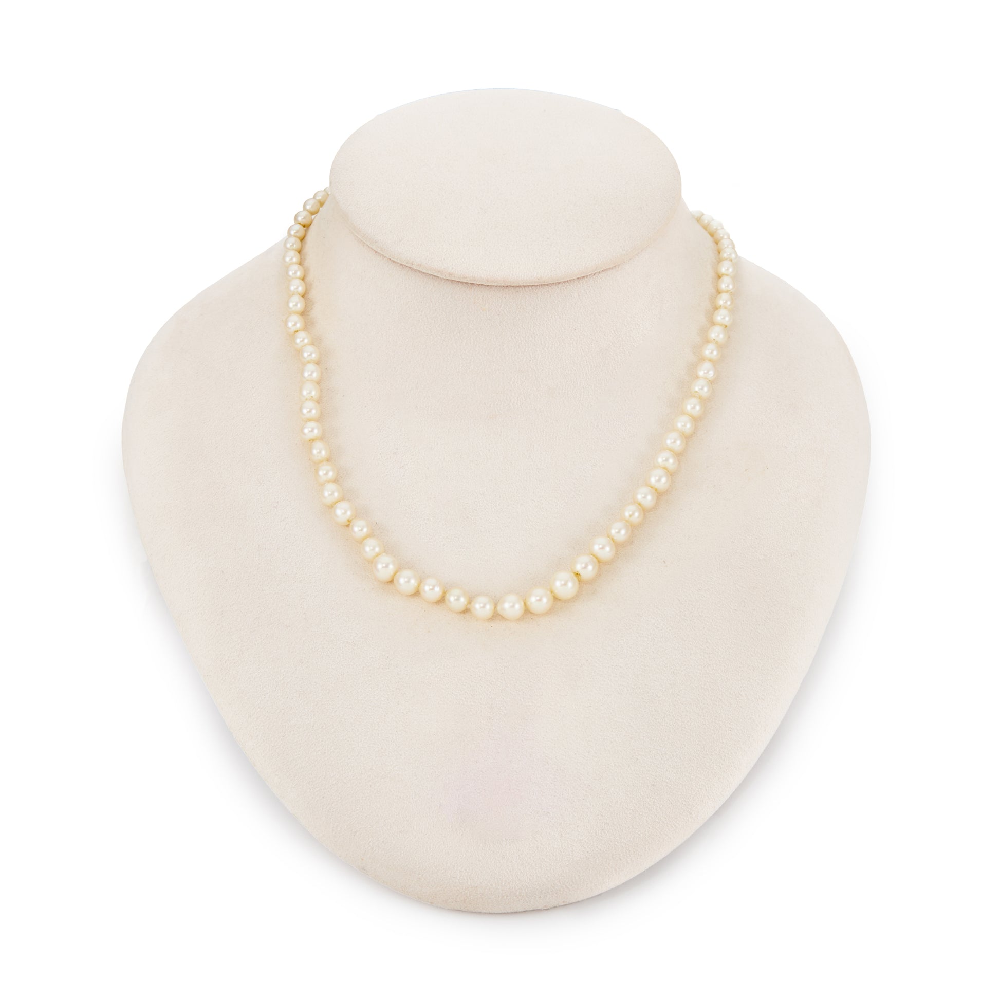 Lustrous graduated string of vintage cultured seawater pearls with a 14ct gold filigree clasp.