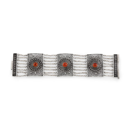 Vintage silver bracelet set with three cabochon carnelian stones. Intricate filigree detail. Turkish.
Maker: Limco