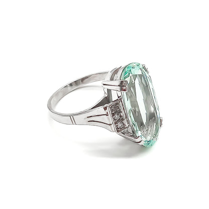 Magnificent 18ct white gold ring set with a beautifully faceted 7ct oval aquamarine and six small diamonds.