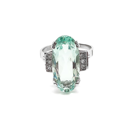 Magnificent 18ct white gold ring set with a beautifully faceted 7ct oval aquamarine and six small diamonds.