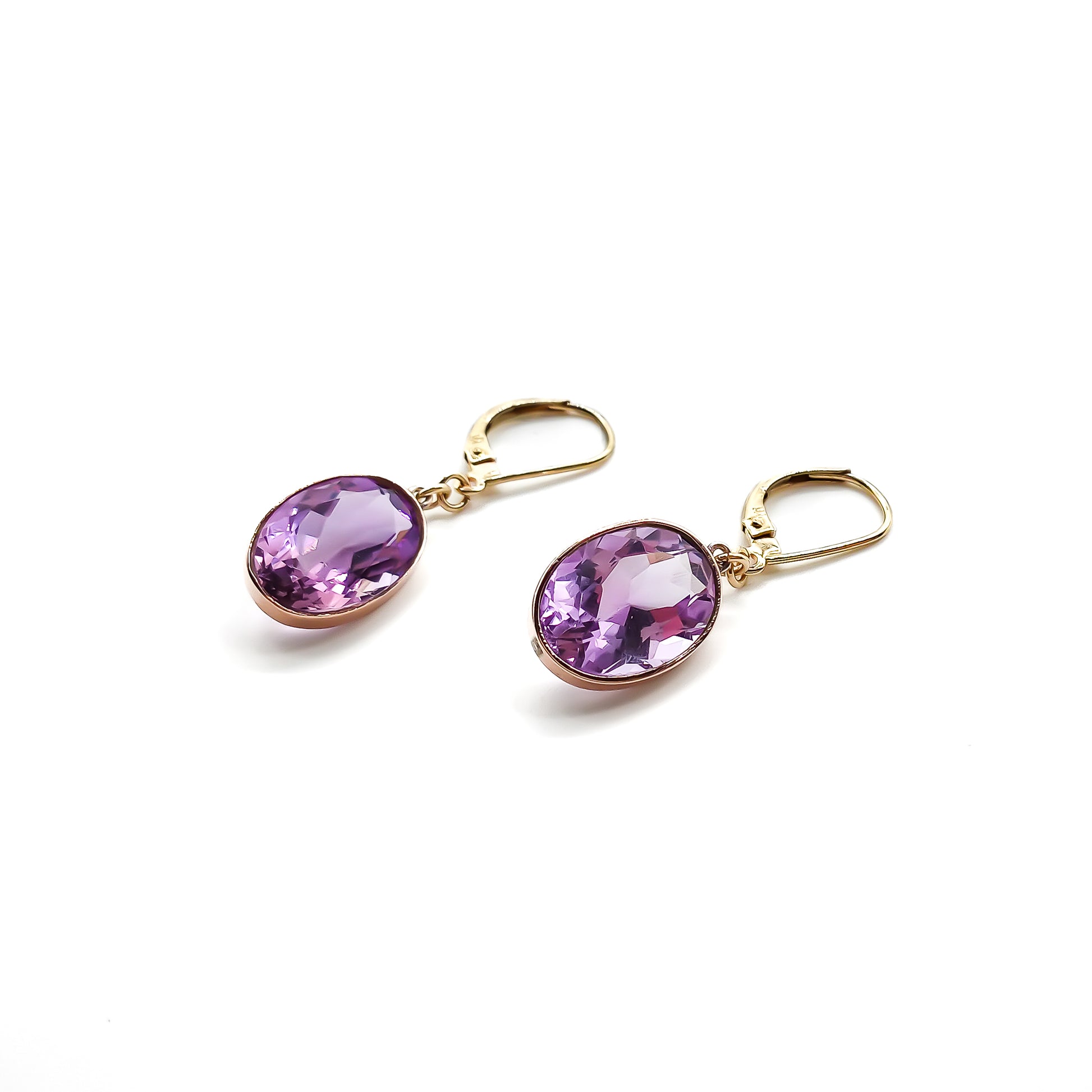 Classic 9ct gold drop earrings set with beautifully faceted oval amethysts.