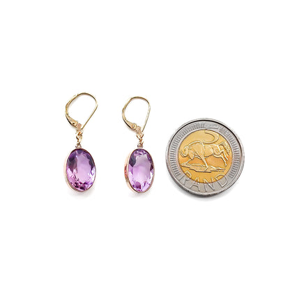 Classic 9ct gold drop earrings set with beautifully faceted oval amethysts.