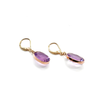 Classic 9ct gold drop earrings set with beautifully faceted oval amethysts.