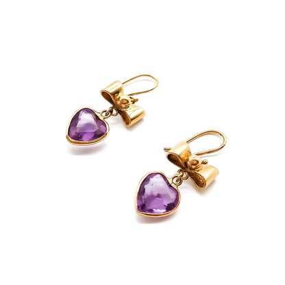 Lovely 9ct yellow gold bow earrings with dangling heart-shaped amethyst drops.