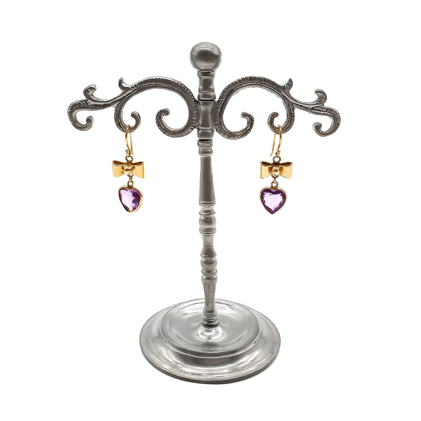 Lovely 9ct yellow gold bow earrings with dangling heart-shaped amethyst drops on earring stand.